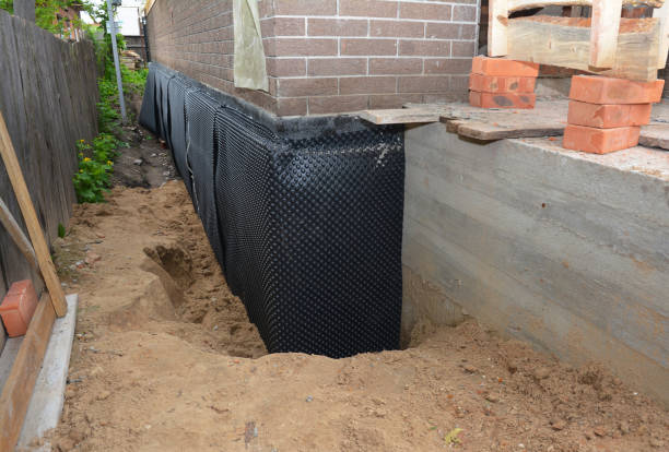 Happy homeowners after waterproofing job in Emerson